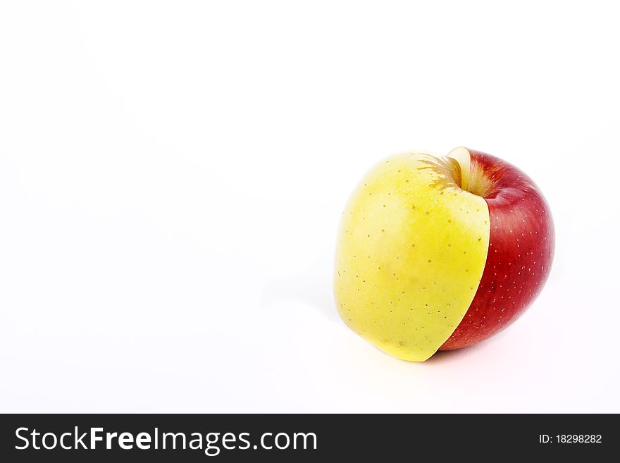 Yellow apple with brown spots on a white background