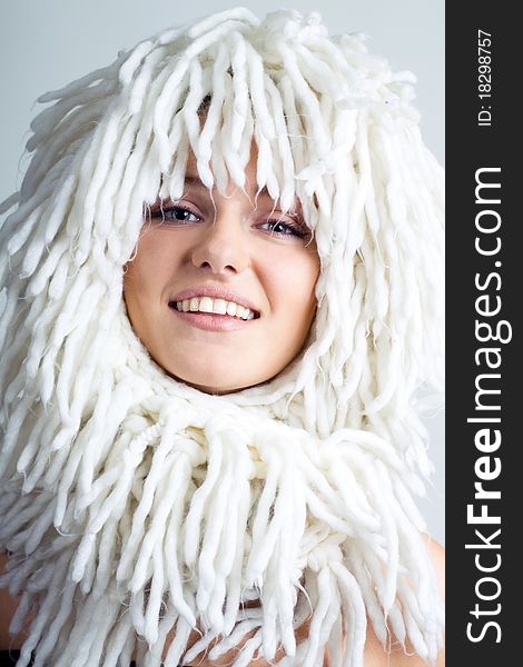 Smiling woman with funny white wig on the head