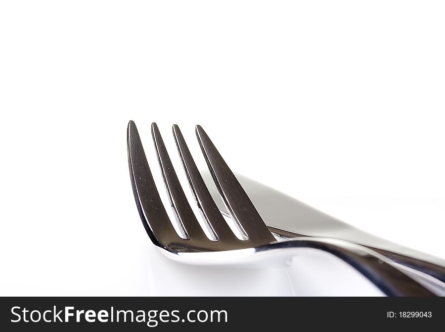 Knife and fork on a white background - tableware.