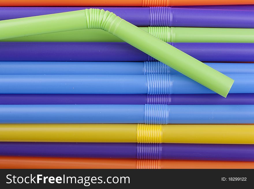 Plastic tubes of different colors in the background.