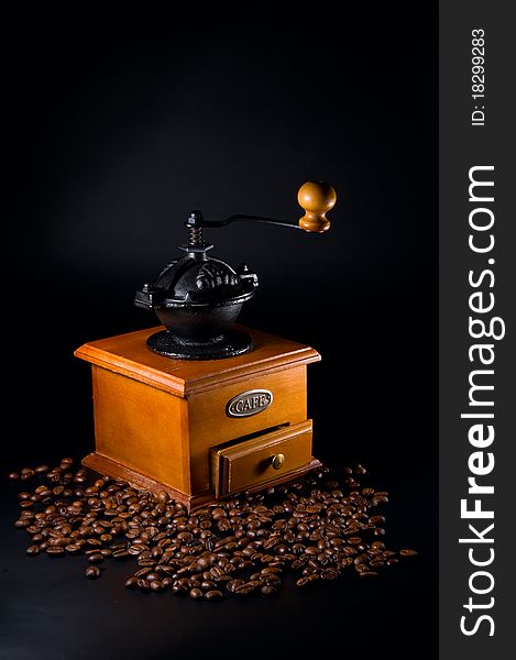 Coffe beans and grinder on a black background. Coffe beans and grinder on a black background