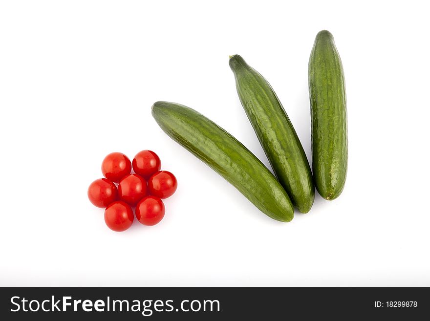 red tomatoes and cucumber on white background