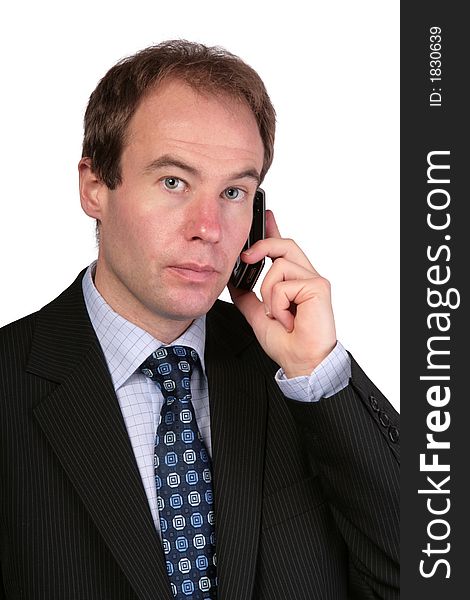 Businessman On Mobile Phone Looking Towards Camera
