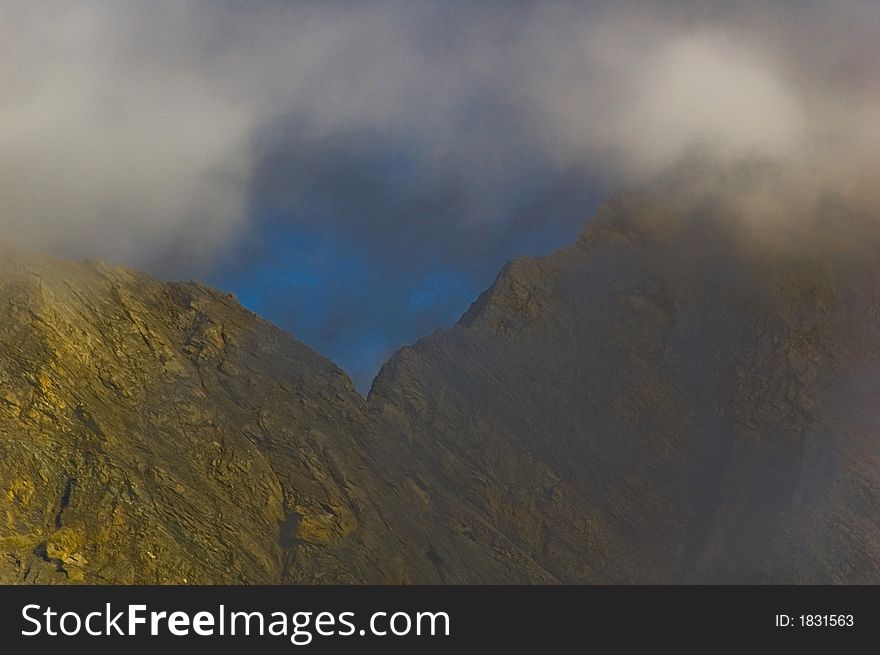 Grossglockner mountain peaks - Austria, Europe.  Horizontal view of peaks with misty clouds. . Grossglockner mountain peaks - Austria, Europe.  Horizontal view of peaks with misty clouds.