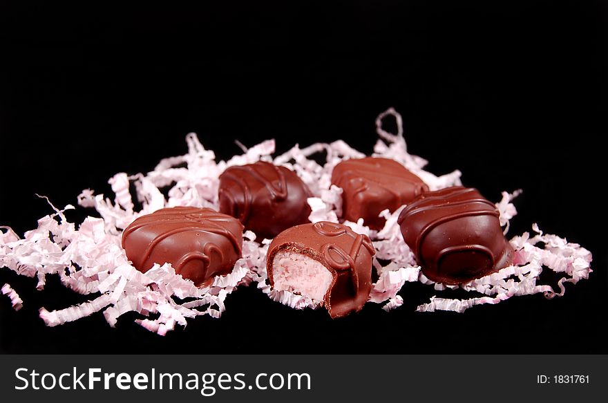 Valentines day chocolates with pink frill on a white background. Valentines day chocolates with pink frill on a white background