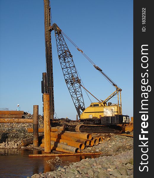 Worker in a jetty operating a crane