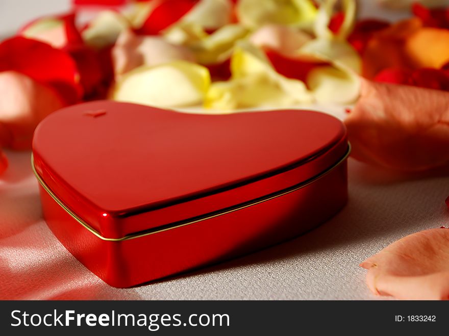 Heart shape box on flower petals for valentines day. Heart shape box on flower petals for valentines day