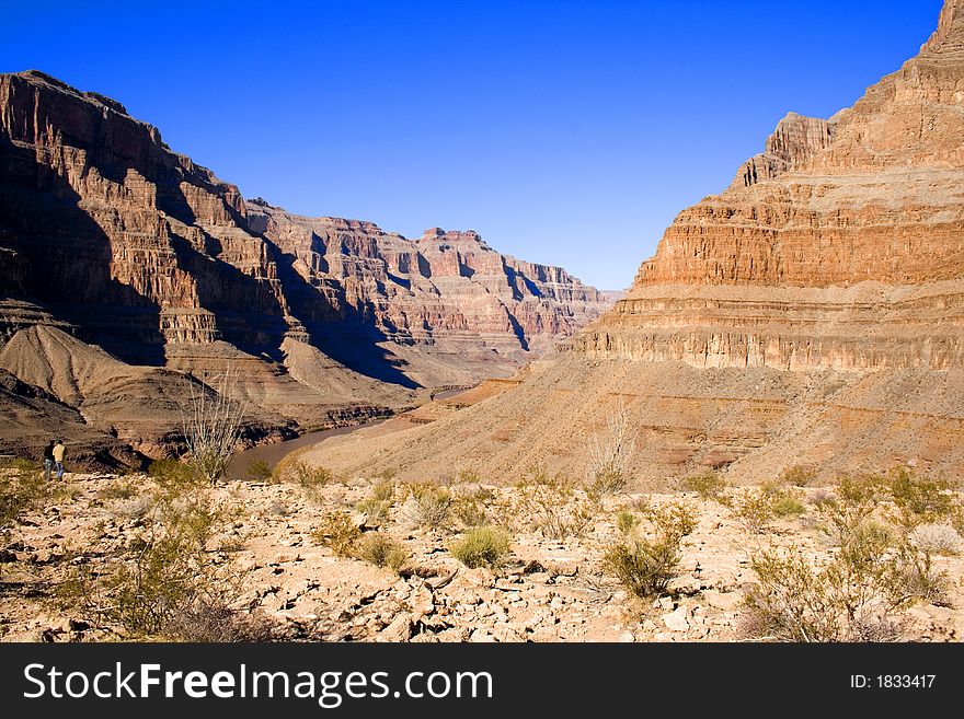 two people looking at Colorado river in The Grand Canyon