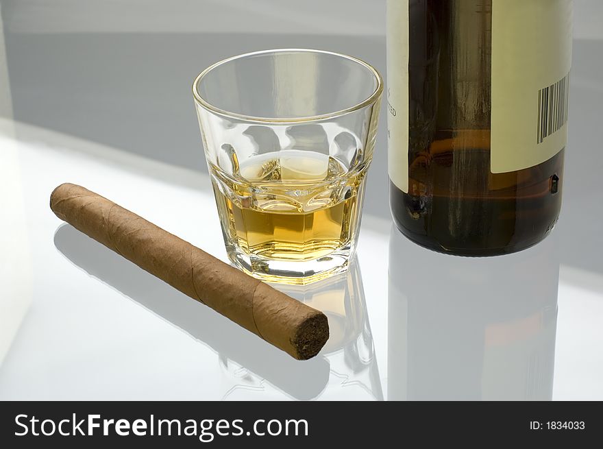 Glass of whiskey and cigar close up shoot