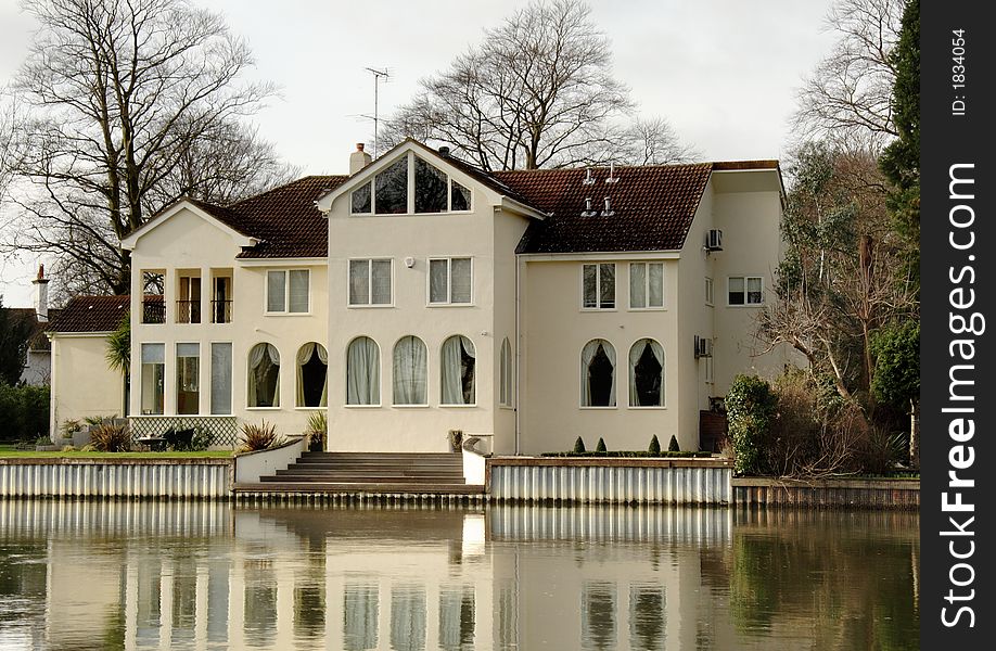 Winter scene of a Luxurious Residence  on the banks of a River in England. Winter scene of a Luxurious Residence  on the banks of a River in England