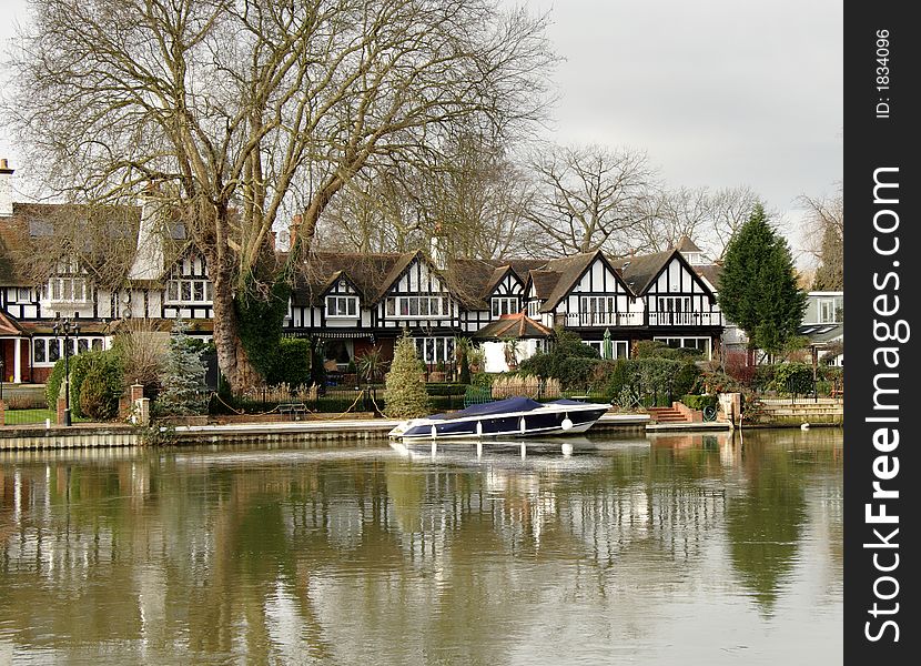 Winter scene of a Luxurious Timber Framed House on the banks of a River in England. Winter scene of a Luxurious Timber Framed House on the banks of a River in England