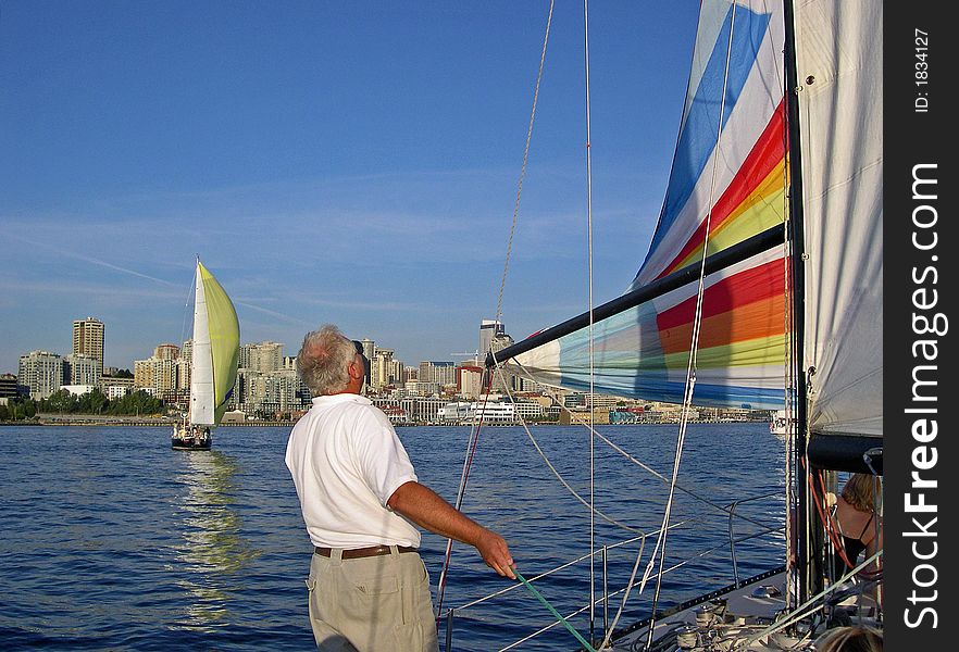 Captain of the sailboat adjusting the spinnaker sail. Captain of the sailboat adjusting the spinnaker sail