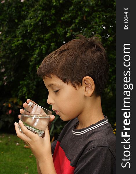Child drinking a glass of fresh water. Child drinking a glass of fresh water
