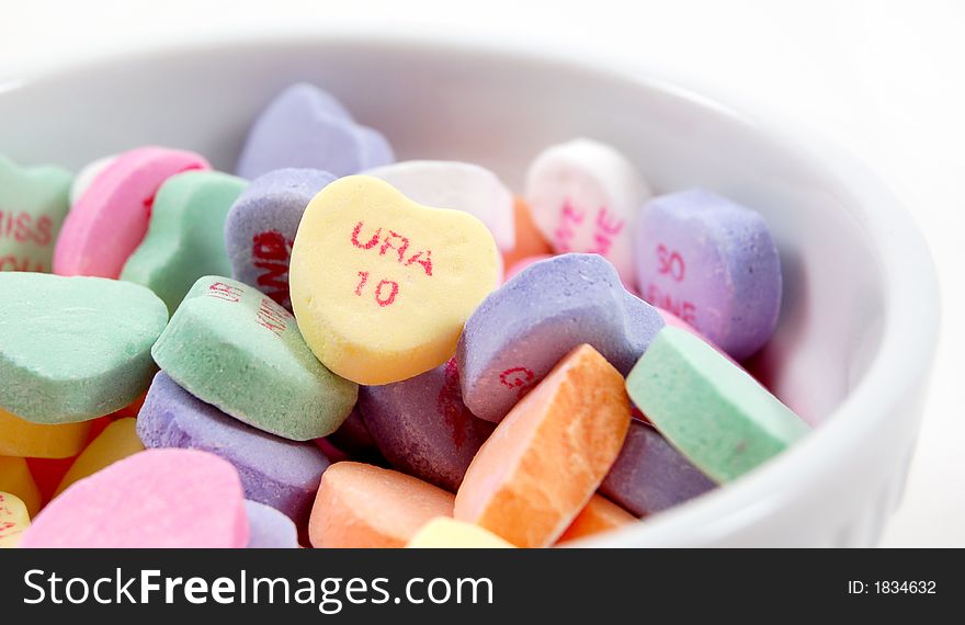 U R A ten valentine's heart shaped candy in a white dish. U R A ten valentine's heart shaped candy in a white dish