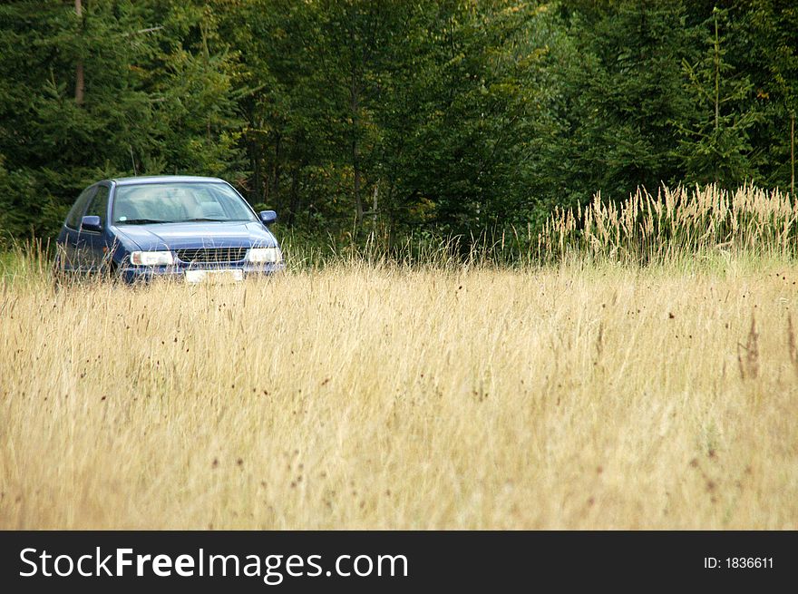 Blue car standing in autumn meadow. Blue car standing in autumn meadow