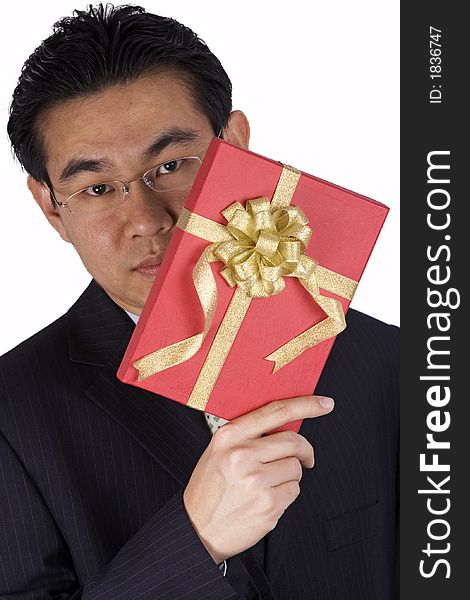 A chinese businessman holding a red present. A chinese businessman holding a red present.