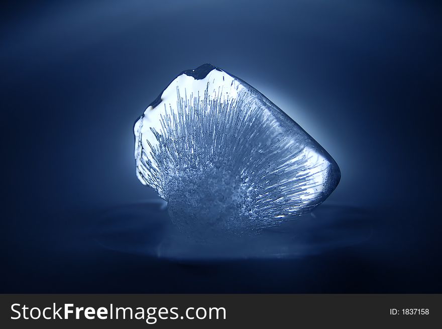 Piece of ice with beautiful structure in blue light. Piece of ice with beautiful structure in blue light