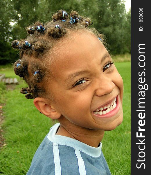 Young smiley brown boy, with hair knots and blue hairbands. Young smiley brown boy, with hair knots and blue hairbands.