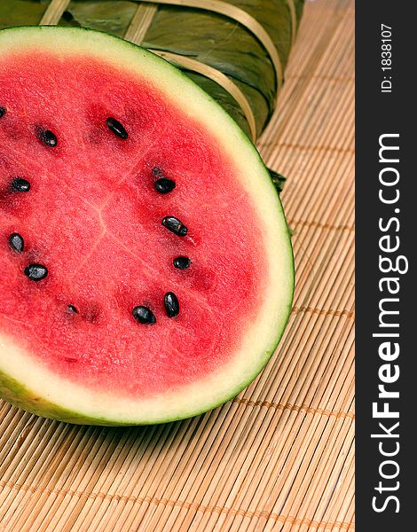 Fresh water melon and rice cake on the rattan background