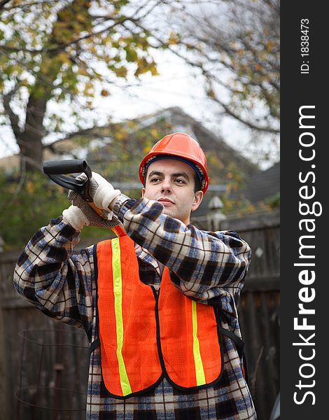 Construction worker holding shovel with both hands on his shoulder. Construction worker holding shovel with both hands on his shoulder