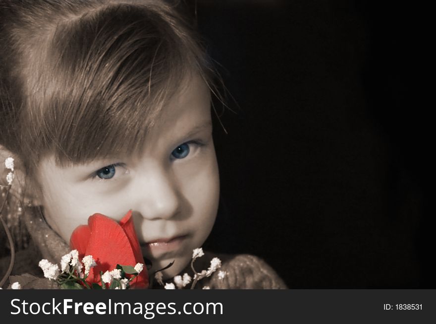 Pretty little girl with serious expression, holding a red rose. Pretty little girl with serious expression, holding a red rose.