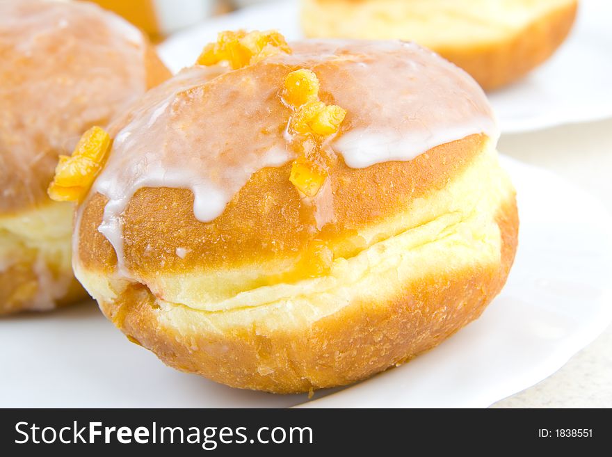 A tasty icing donut with orange zest. A tasty icing donut with orange zest.