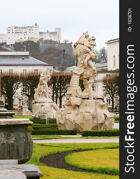 A few statues in the gardens of Mirabell Palace in Salzburg, Austria, with its castle in the background. A few statues in the gardens of Mirabell Palace in Salzburg, Austria, with its castle in the background