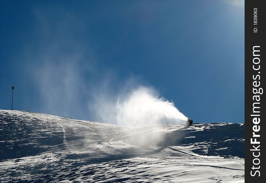 Snow-gun working on a ski slope ,Alps ski resort. Snow-gun working on a ski slope ,Alps ski resort