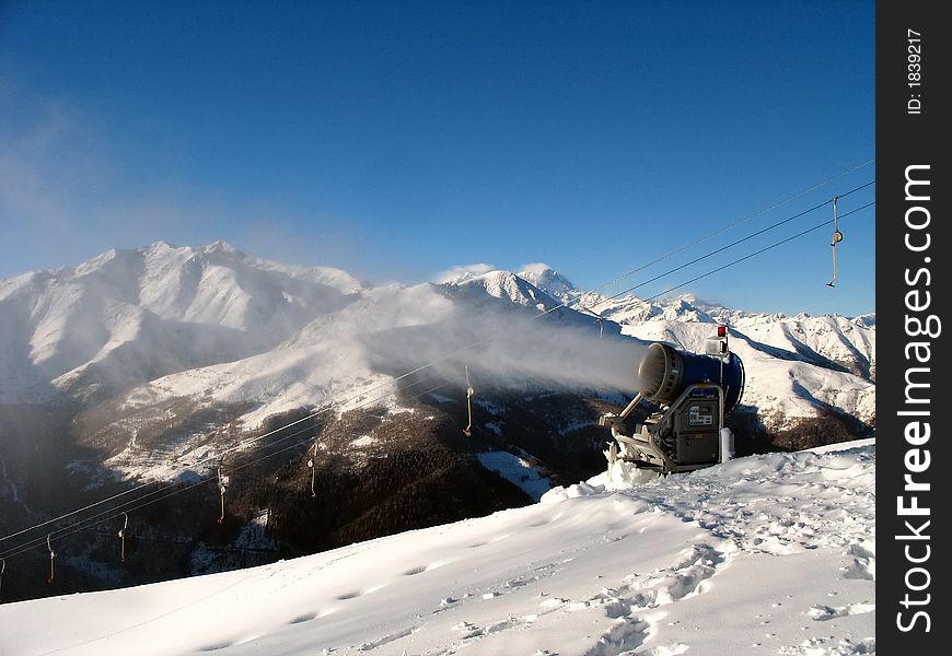 Snow-gun working on a ski slope ,Alps ski resort. Snow-gun working on a ski slope ,Alps ski resort