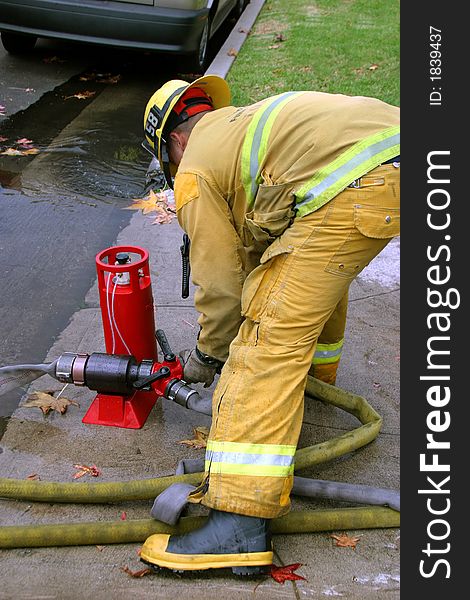Fireman setting a water supply. Fireman setting a water supply