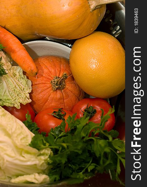 Fresh vegetables - tomatoes, cabbage, carrot, parsley, pumpkin - on the plates