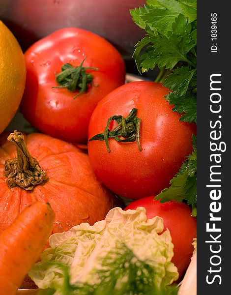Fresh vegetables - tomatoes, pumpkin, carrot, cabbage, parsley - on the metallic plate