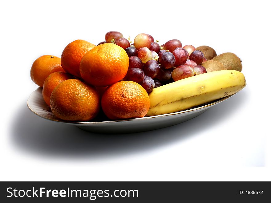 Dish of fruits isolated on white