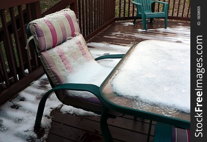 Photo of snow on patio chair on a outside deck in the winter