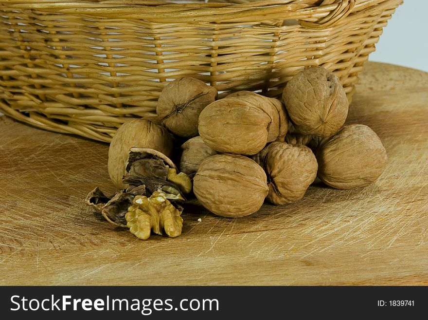 Walnuts in front of a litle basket. Walnuts in front of a litle basket