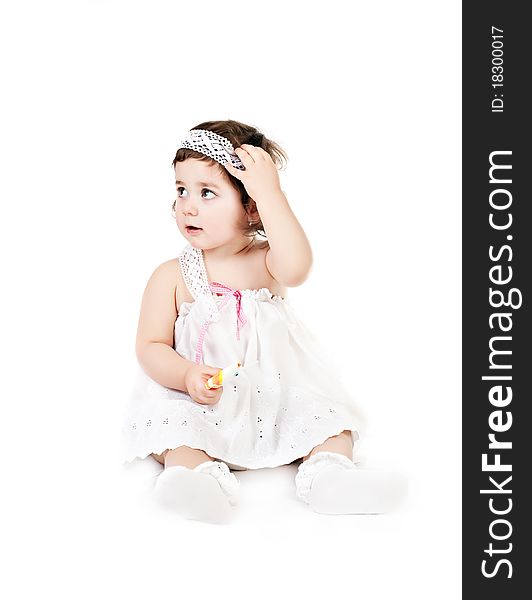 Baby girl in a white dress isolated on white