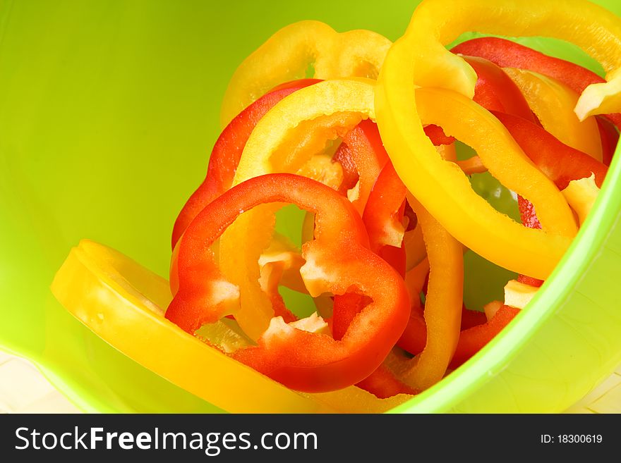 Sliced sweet peppers on bright green background