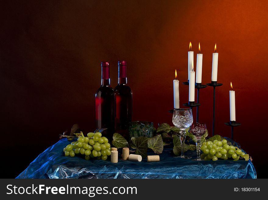 Arrangement of wine bottle, glass, grapes, vine plant, corks in studio. Arrangement of wine bottle, glass, grapes, vine plant, corks in studio