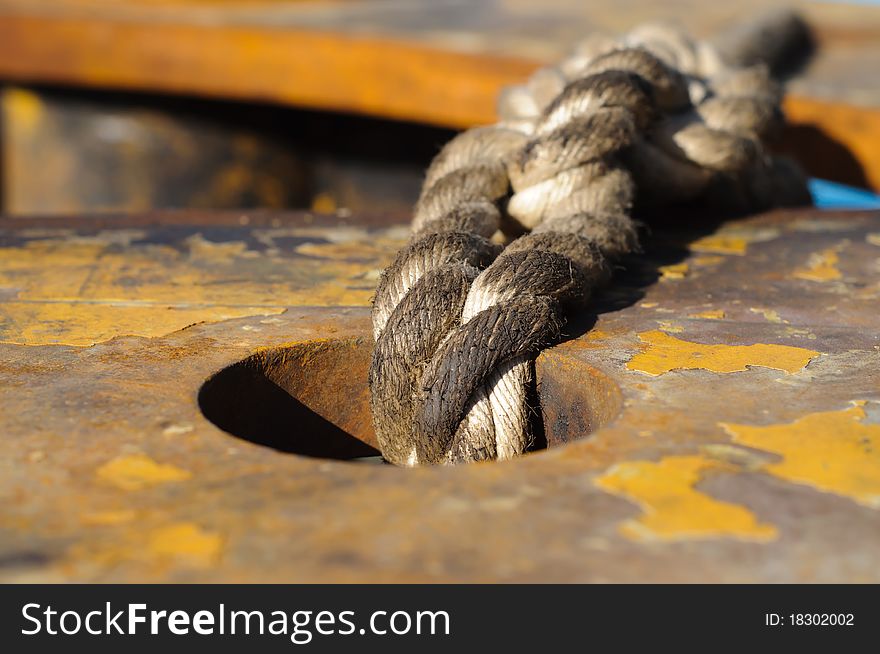 Oily rope  placed in hole in metal plade