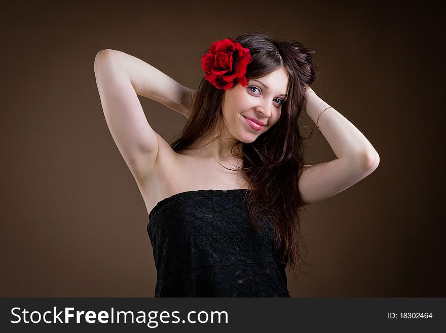 Portrait of attractive woman with flower in hair
