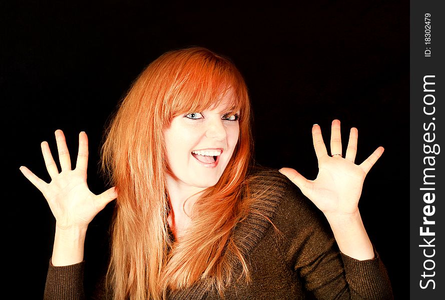 Young Red-haired Girl Smiling On A Dark Background