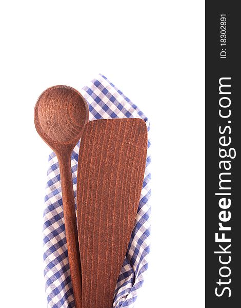 Dishtowel and wooden spoon isolated on white background