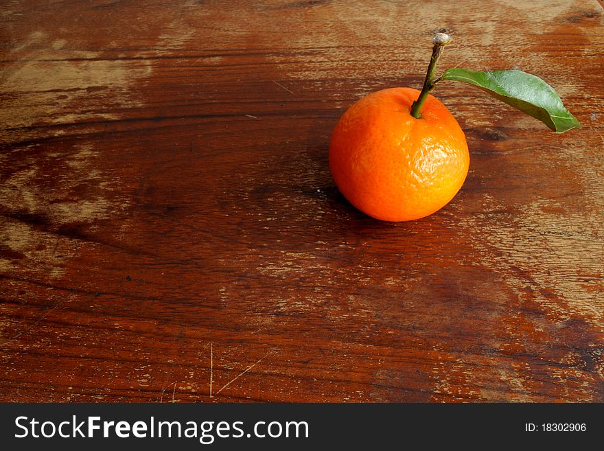 Mandarins and the leaves on a wooden table. Mandarins and the leaves on a wooden table