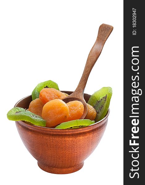 Dry apricot and kiwi on wooden dish