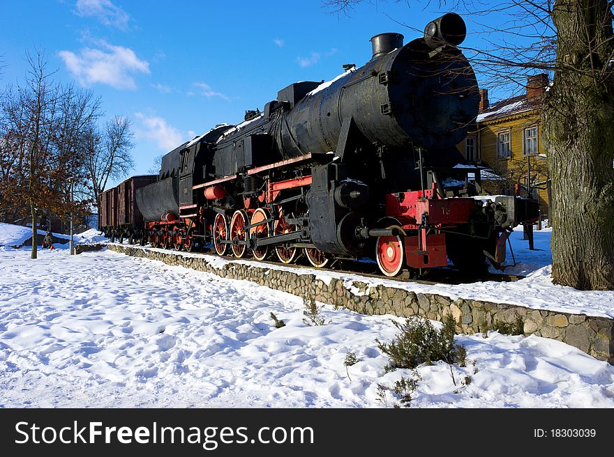 Old fashioned black - red locomotive as a monument. Old fashioned black - red locomotive as a monument