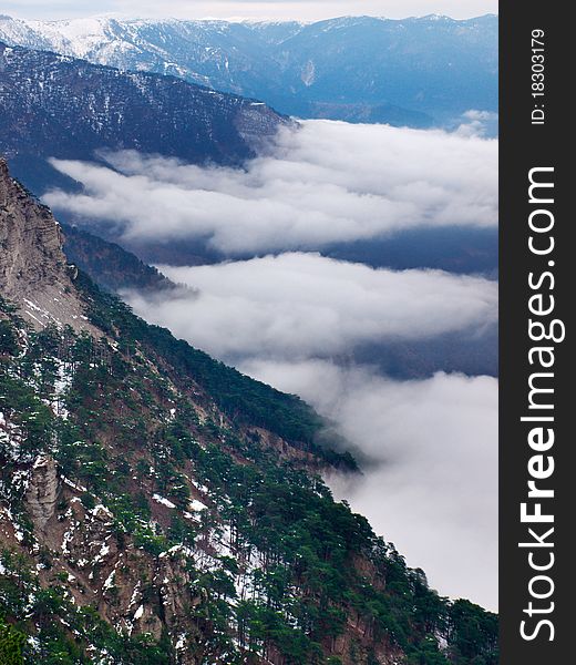 Mountain valley with declivity and white cloud. Composition of the nature