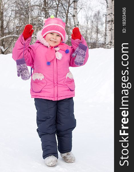 Girl smiling in winter mittens.