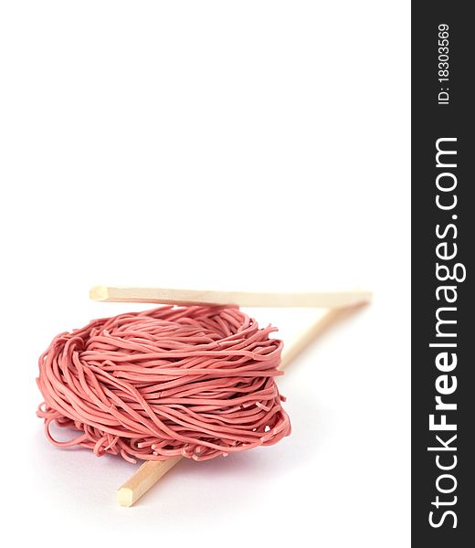 Red noodles and chopsticks isolated on white background