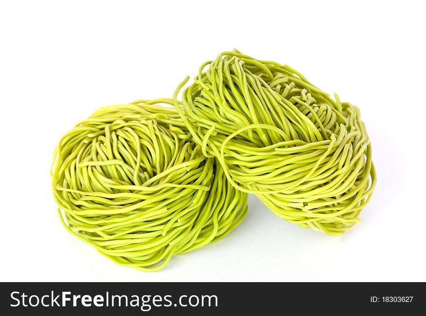 Raw green pasta isolated on white background