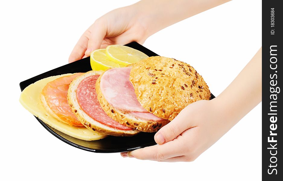 Sandwich on a plate in hands. Isolated on white.